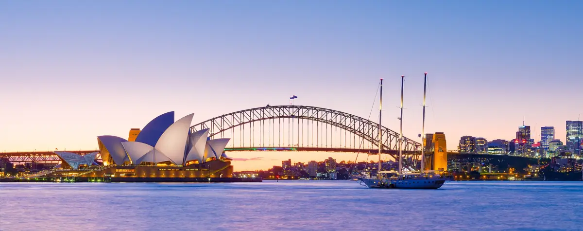 Sydney Harbour at dusk with the Opera House and the Harbour Bridge